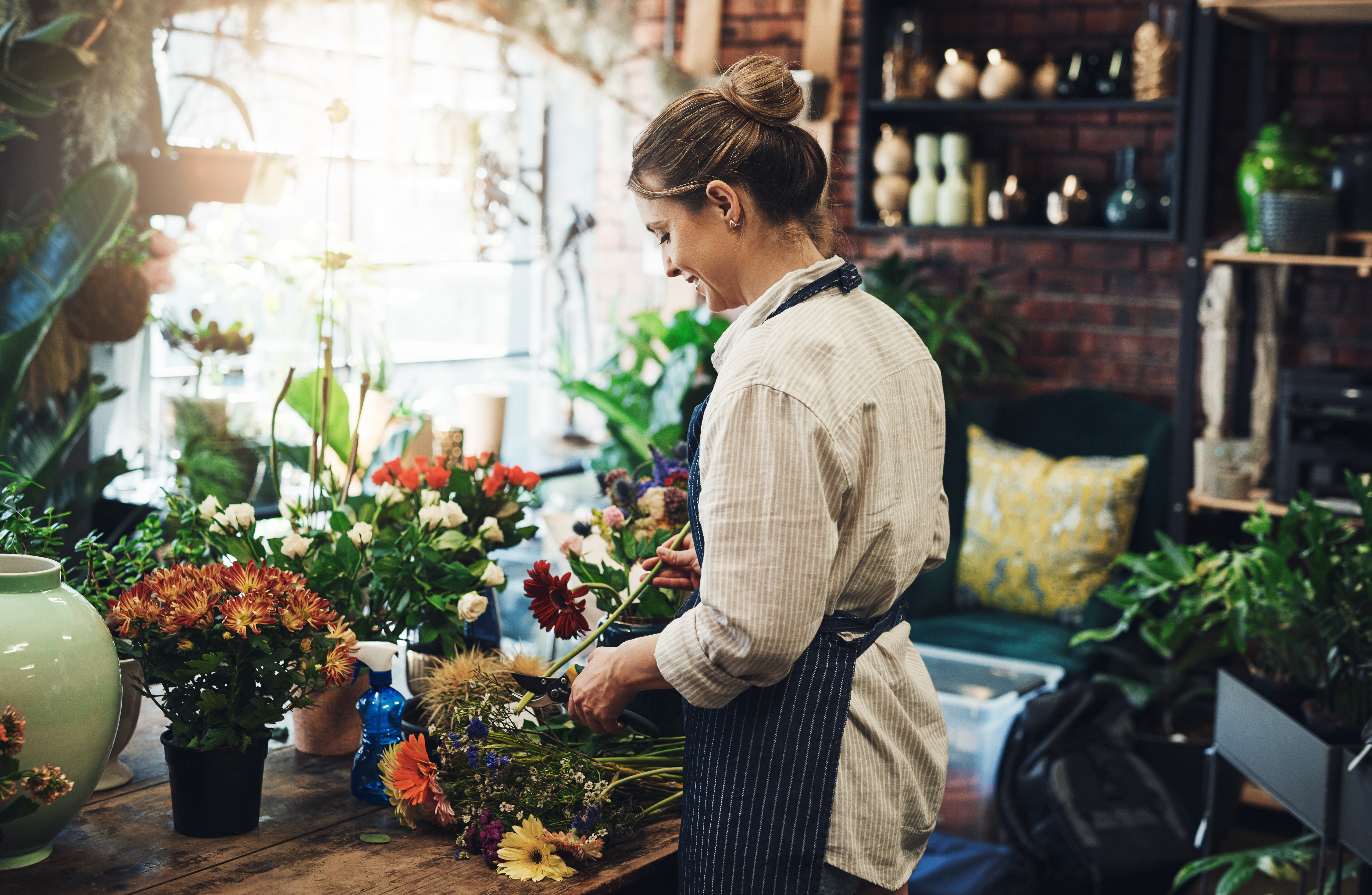 Woman arranging flowers in her flower shop 2026 03 25 03 56 00 utc